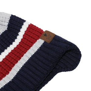 Close-up of multicolor striped knit texture with a brown leather Super Star logo tag