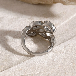 Detail of silver floral zircon ring on stone base showing back structure and metal texture