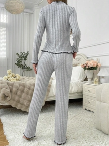 Back view of grey ribbed pajama set with black lettuce trim and long straight pants