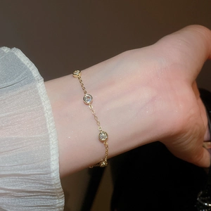 Close-up of a gold chain bracelet with sparkling round zircons on an elegant wrist