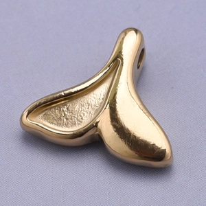 Close-up of golden 18k plated 304 stainless steel fishtail pendant with hammered texture