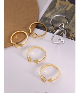 Detailed close-up of 18K gold and silver adjustable heart arrow rings for women