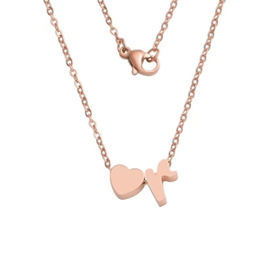 Macro view of rose gold heart pendant and lowercase r letter charm on O-chain