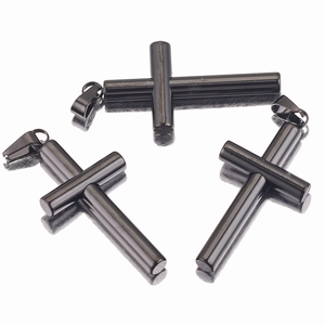 Detailed view of three glossy black stainless steel cylindrical cross pendants for necklaces