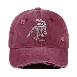Distressed burgundy baseball cap featuring detailed white dinosaur skeleton embroidery.