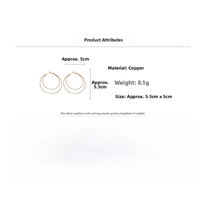 Detail view of 5.5cm golden double hoop earrings with copper base and silver needle