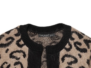 Detailed view of the leopard print knit cardigan collar and ZEAL WOMAN brand label