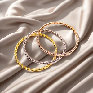 Detail showing twisted rope texture bracelets in gold, rose gold, and silver finishes