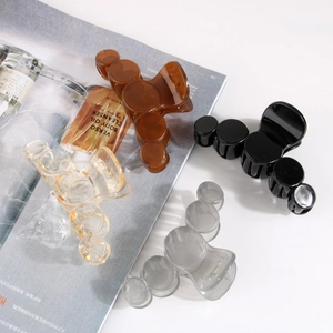 Detailed set of four plastic bubble hair claws in gold foil, amber, black, and grey colors