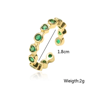 Detail showing 18K gold plated ring dimensions 1.8cm diameter and 2g weight with green gems