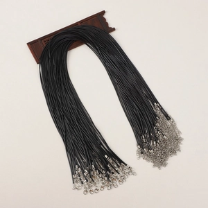 Detail view of black waxed necklace cords with silver lobster clasps and extension chains