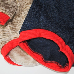 Close-up of thick fleece lining and red ribbed cuffs on this warm dog sweatshirt