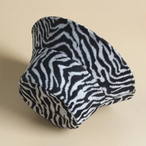 Macro detail of the soft black and white zebra print texture on this plush winter bucket hat
