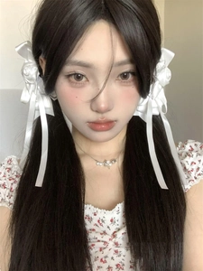 Close-up of sweet white rose ribbon hair clips worn on twin ponytails in lolita style
