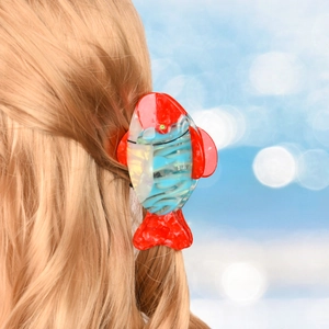 Close-up of tropical fish hair claw clip made of colorful acetate on blonde hair