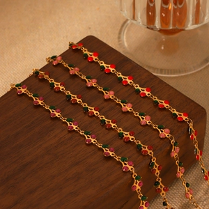 Detailed view of colorful enamel cherry bracelets in 18K gold plated stainless steel