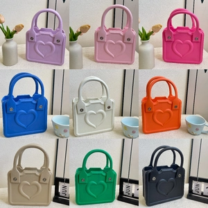Detailed grid display of small EVA tote bags featuring a 3D heart pattern in nine vibrant colors