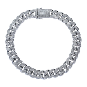 Macro shot of silver Cuban link chain with iced out stones and a secure square box clasp