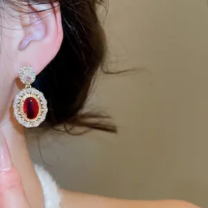 Vintage gold plated oval drop earrings with red zircon and sparkling white stones