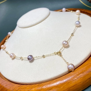 Elegant 14K gold filled necklace with multicolored freshwater pearls on a display stand