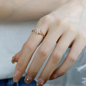 Detail of a floral S925 silver ring with white opal petals and sparkling zircon accents