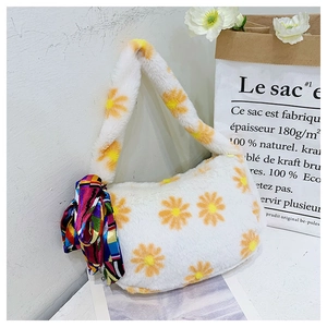Detail of white fluffy handbag with orange daisy floral pattern and colorful silk scarf
