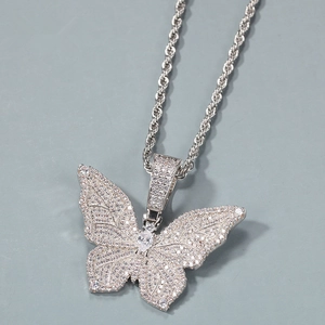 Macro shot of silver butterfly pendant with sparkling cubic zirconia on a twisted rope chain