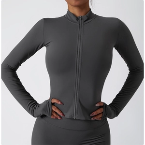 Detailed view of long sleeve sports top featuring thumbholes and functional full zip closure