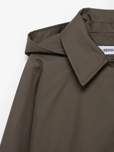 Detailed macro view of dark olive waterproof trench coat neckline and hood texture