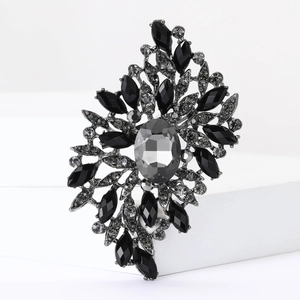 Macro shot of large rhinestone brooch with grey crystals and ornate flower leaf design