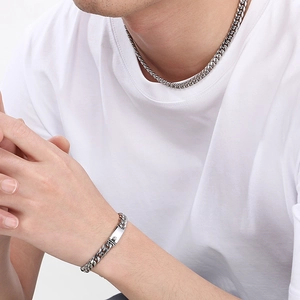 Detailed view of silver 8mm Cuban link necklace and matching rectangular plate bracelet