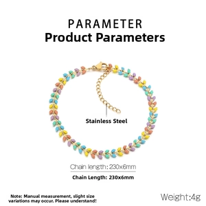 Detailed view of colorful enamel leaf charms on a gold stainless steel beach anklet