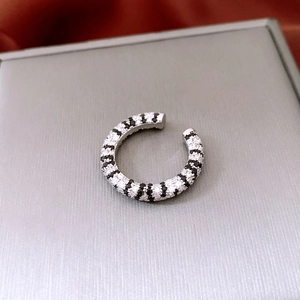 Macro detail of French vintage silver ring with black and white pavé zircon stripes
