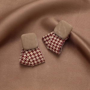 Detail view of retro houndstooth fabric earrings with square khaki resin studs