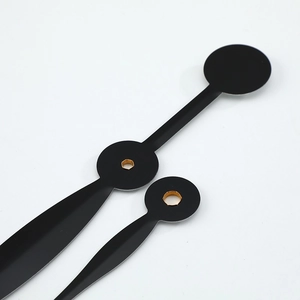 Three-piece matte black quartz clock hands set with golden mounting holes on white background