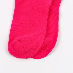Close-up showing the fine knit texture and toe seam of vibrant pink calf-high socks.