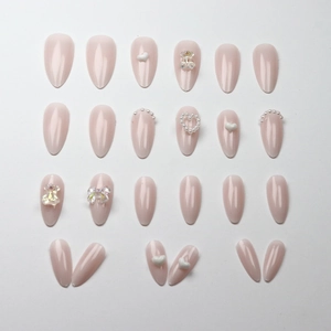 Pink press-on nails set with gold-plated bear and bow decorations and pearls
