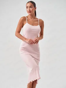 Detail of light pink floral slip dress featuring textured heart pattern and wavy hemline