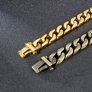 Close-up of gold and bronze Cuban link bracelets showing durable metal clasp and texture