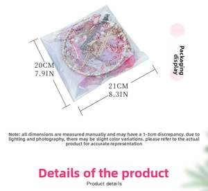 Pink and white handmade dreamcatcher with feathers and lace in protective packaging