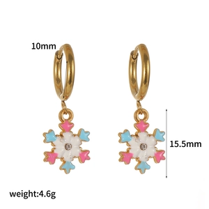 Detail of gold hoops with colorful enamel snowflakes and precise size measurements