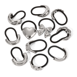 Detailed view of silver stainless steel hair ties featuring heart and bow metal charms