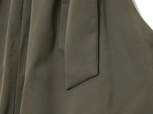 Close-up detail of the army green tie-up belt and textured fabric on the sexy halter top