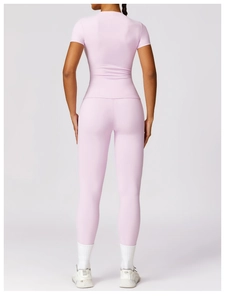 Back view of high-elastic pink yoga top and matching high-waisted fitness leggings