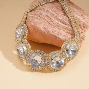 Exquisite gold statement necklace with large round crystals and pavé diamonds on a raw stone