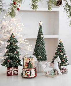 Detailed close-up of resin Christmas tree ornaments and a Santa snow globe decor