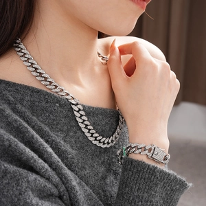 Macro shot of silver punk chain necklace and bracelet set with sparkling diamonds