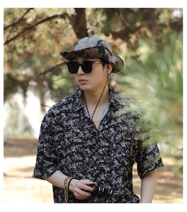 Detail of camouflage sun hat with adjustable windproof cord in outdoor forest setting