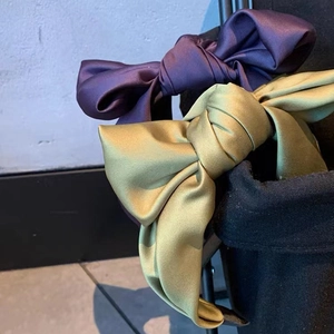 Elegant purple and olive green satin bow headbands with a premium glossy silk finish