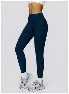 Detail of high-waisted thermal yoga pants with seamless texture and dark blue finish